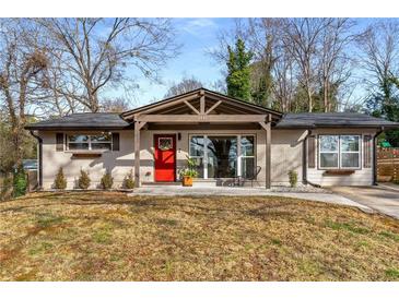 Charming brick home featuring a striking red door and inviting front porch area at 3430 Pinehill Dr, Decatur, GA 30032