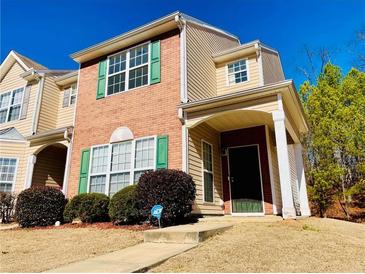 Charming townhome featuring brick facade and a welcoming covered front porch at 5070 Oakley Commons Blvd, Union City, GA 30291