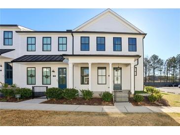 Charming two-story townhome featuring a black metal roof and eye-catching black-framed windows at 83 Arnold Poplar Ln, Auburn, GA 30011