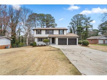 Charming two-story home featuring a two-car garage and well-maintained landscaping, perfect for suburban living at 2167 Cedar Dr, Lawrenceville, GA 30043