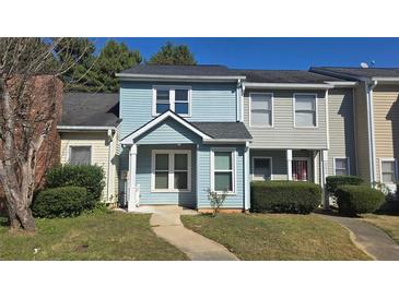 Charming townhouse featuring a quaint entryway and well-maintained landscaping at 2173 Wellington Cir, Lithonia, GA 30058