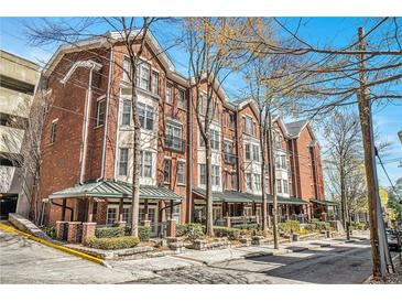 Brick building with a traditional design and inviting covered entrances and manicured landscaping at 850 Piedmont Ne Ave # 1302, Atlanta, GA 30308