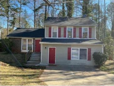 Charming two-story home featuring red shutters and a well-maintained lawn at 5338 Timor Trl, Lithonia, GA 30038