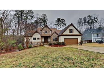 Charming two-story home with a stone facade and well-manicured lawn at 50 Senator Lake Dr, Douglasville, GA 30134