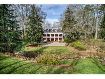 Stately brick home with large columns, mature trees, and a well-manicured lawn at 0 Winterthur, Sandy Springs, GA 30328