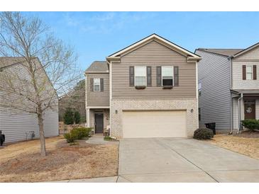 Two-story home with neutral siding, brick accents, an attached two-car garage, and a well-maintained front yard at 120 Centennial Ridge Dr, Acworth, GA 30102