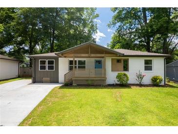 Charming bungalow with a blue front door, modern colors, and a welcoming front porch at 3235 Bluebird Ln, Decatur, GA 30032