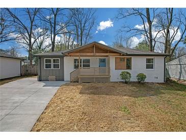 Charming single-story home with a welcoming front porch and modern exterior paint scheme at 3235 Bluebird Ln, Decatur, GA 30032