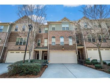 Beautiful brick townhouse with attached garages and meticulously maintained landscaping at 2402 Palladian Manor Se Way # 3, Atlanta, GA 30339