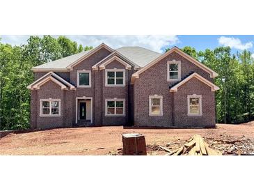 New two story home shows brick facade, double windows, and neutral trim on a sunny day at 211 Lotus Ln, Covington, GA 30016