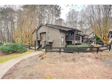 Two-story condo featuring private balconies, natural landscaping, and neutral color palette at 1804 Cumberland Se Ct, Smyrna, GA 30080