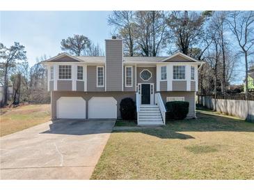 Charming two-story home featuring a two-car garage and inviting front porch with nice landscaping at 600 Canterbury Ln, Lawrenceville, GA 30046