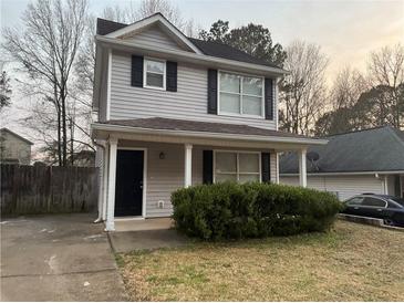 Charming two-story home with a well-maintained front yard and covered porch at 115 Glynn Addy Dr, Stockbridge, GA 30281