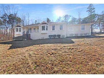 Charming single-story home featuring a stucco facade, bay windows, and a well-manicured front lawn at 156 Page Pl, Canton, GA 30114