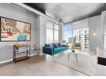 Stylish living room featuring concrete accents, large windows, and modern furnishings at 250 Pharr Ne Rd # 1702, Atlanta, GA 30305
