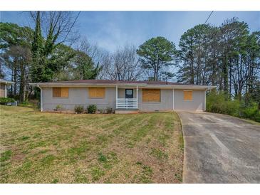 Charming single-story home with a well-maintained lawn and a long private driveway at 4094 E Glade Ct, Decatur, GA 30035