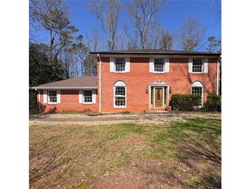 Charming two-story brick home with symmetrical design and classic white window shutters at 4625 Orkney Sw Ln, Atlanta, GA 30331