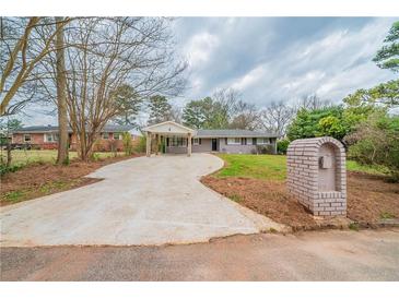 Charming ranch-style home featuring a covered carport and a well-maintained front yard at 3680 Brookcrest Cir, Decatur, GA 30032