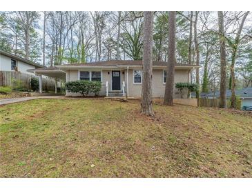 Charming single-story home with a manicured lawn and mature trees offering curb appeal at 1624 Linda Dr, Decatur, GA 30032