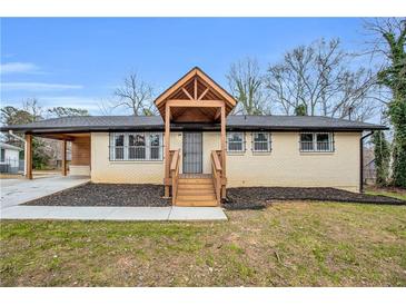 Charming single-story home featuring a front porch with wood columns and fresh landscaping at 2000 Fairburn Sw Rd, Atlanta, GA 30331