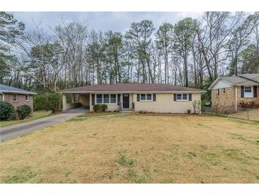 Charming single-story home featuring a well-maintained lawn and a covered carport at 3202 Betty Cir, Decatur, GA 30032