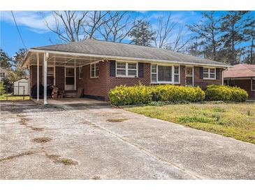Cozy brick home featuring a covered carport and manicured front yard, perfect for easy access and curb appeal at 965 Laurel St, Morrow, GA 30260
