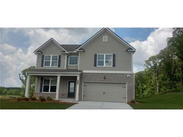 Charming two-story home featuring a gray exterior, brick accents, and an attached two-car garage at 6005 Spring Way, Stonecrest, GA 30038