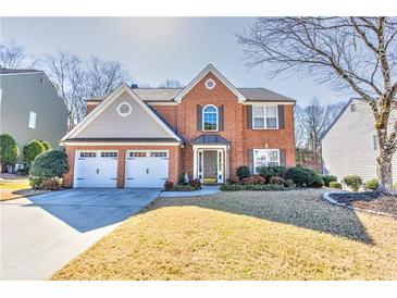 Charming two-story brick home with a well-manicured lawn and a two-car garage at 1510 Ridgemill Ter, Dacula, GA 30019