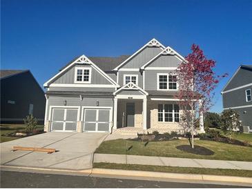 Stunning two-story home featuring a two-car garage and a beautifully landscaped front yard at 320 Willow Cv, Canton, GA 30114