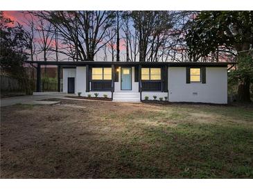 Charming renovated home featuring a blue front door and modern black and white accents at 1383 Palmer Sw Pl, Mableton, GA 30126