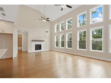 Bright living room with hardwood floors, fireplace and large windows providing an abundance of natural light at 537 Pearl St, Cumming, GA 30040