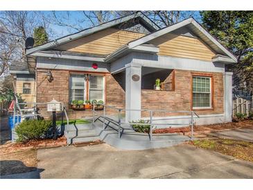 Charming home featuring stone accents, a cozy front porch, and well-maintained landscaping at 799 Moreland Se Ave, Atlanta, GA 30316