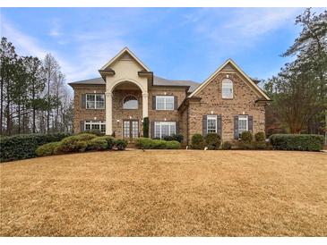 Stunning two-story brick home with a manicured lawn and beautiful landscaping at 6111 Sequoia Ln, Douglasville, GA 30135