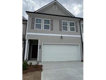 Two-story townhome features a gray exterior, shuttered windows, and a two-car garage at 1118 Edinburg Dr # 60, Villa Rica, GA 30180