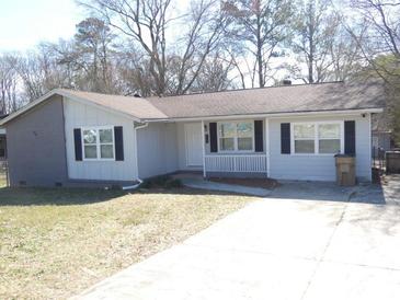 Charming single story home with a gray exterior, manicured lawn, and paved driveway, creating a welcoming curb appeal at 123 Oldenburg Dr, Riverdale, GA 30274
