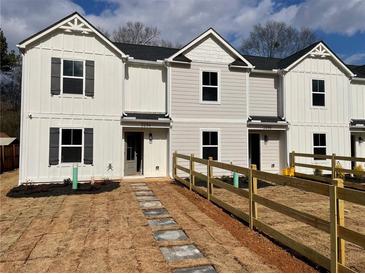 New townhouse with white siding, black shutters, and a small front yard with a wooden fence at 229 Evergreen Trail Unit C, Cartersville, GA 30121