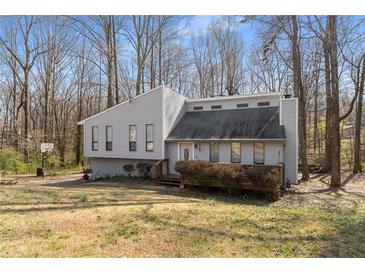Charming split-level home features unique architecture, mature trees and a quaint front yard at 3747 Junior Ln, Douglasville, GA 30135
