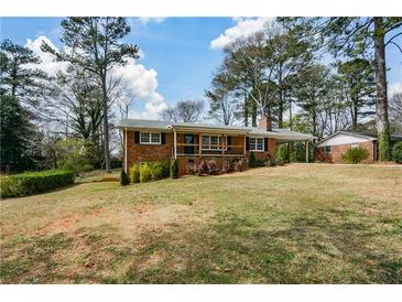 Charming brick home with a covered front porch and large front yard at 1703 Alton Way, Marietta, GA 30062