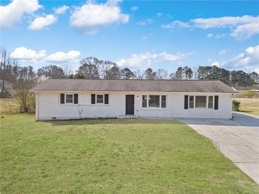 Charming single-story home with a brick facade, black shutters, and a well-manicured lawn at 708 Morris Rd, Hiram, GA 30141