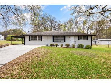 Charming one-story home with a well-manicured lawn and a convenient carport at 4611 Old Westside Rd, Austell, GA 30106