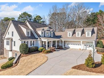 Stately two-story home with a large driveway, attached garage and well-manicured landscaping at 332 William Dr, Canton, GA 30114