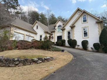 Charming home with white stucco, arched windows, and a well-manicured front yard at 4508 Bankside Court, Marietta, GA 30066