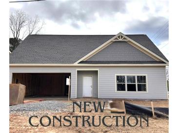 New construction home featuring light gray siding, gray shingles, and an attached two car garage at 4755 Fowler St, Acworth, GA 30101