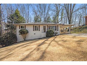 Charming single story home with a carport, front lawn and mature trees at 46 Cooper Lake Sw Rd, Mableton, GA 30126