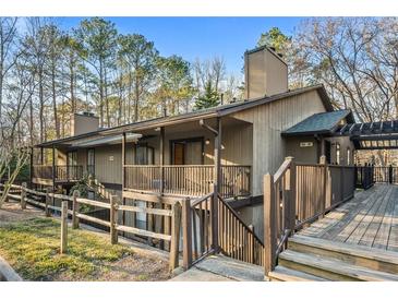 View of exterior featuring wood siding, balcony, and natural surroundings at 104 River Run Dr, Atlanta, GA 30350