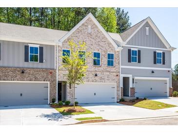 Beautiful brick townhome with an attached garage and modern architectural details at 1604 Ruskin Way, Marietta, GA 30062