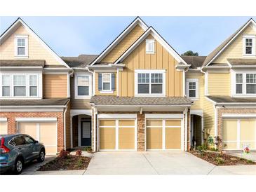 Charming townhome with two-car garage and attractive curb appeal at 1670 Granville Ct, Lawrenceville, GA 30043