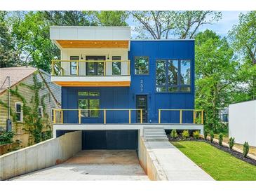 Modern home showcasing a striking blue exterior with a balcony and a well-manicured front yard at 237 Altoona Sw Pl, Atlanta, GA 30314