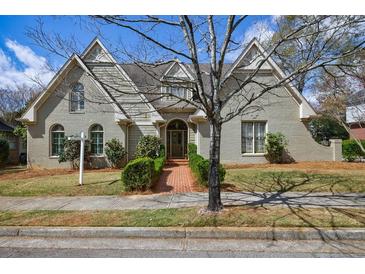 Charming home showcasing a brick walkway, well-manicured lawn, and beautiful architecture at 5 Coventry Close, Avondale Estates, GA 30002