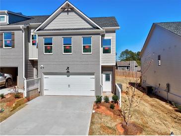 New two-story gray home with a two-car garage and professionally landscaped front yard at 1337 Fern Ridge Ct # 28, Norcross, GA 30093